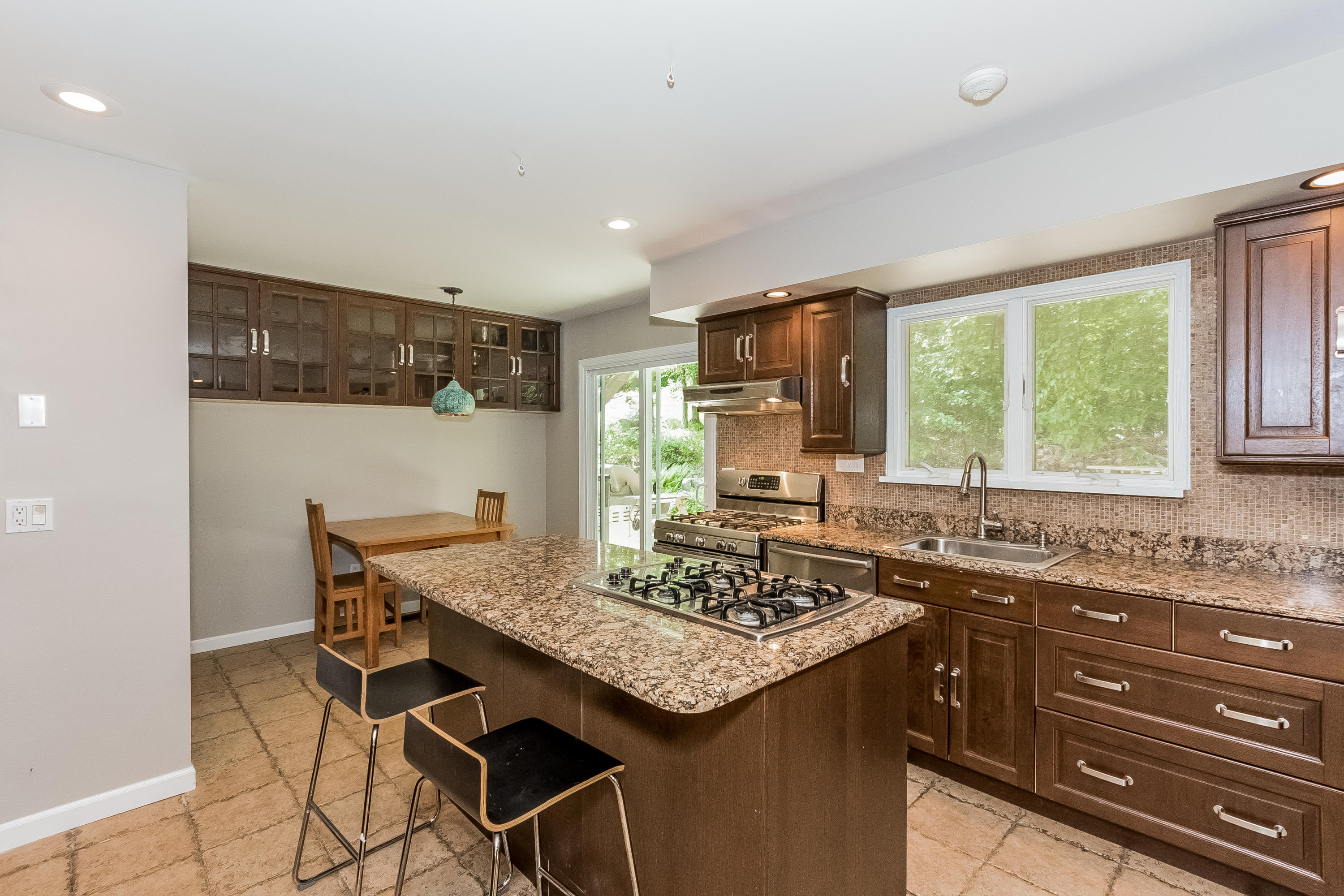 17 Bayberry Hill Road Ridgefield, CT 06877 - Photo 17 of 50 a kitchen with a stove a sink a refrigerator and wooden cabinets