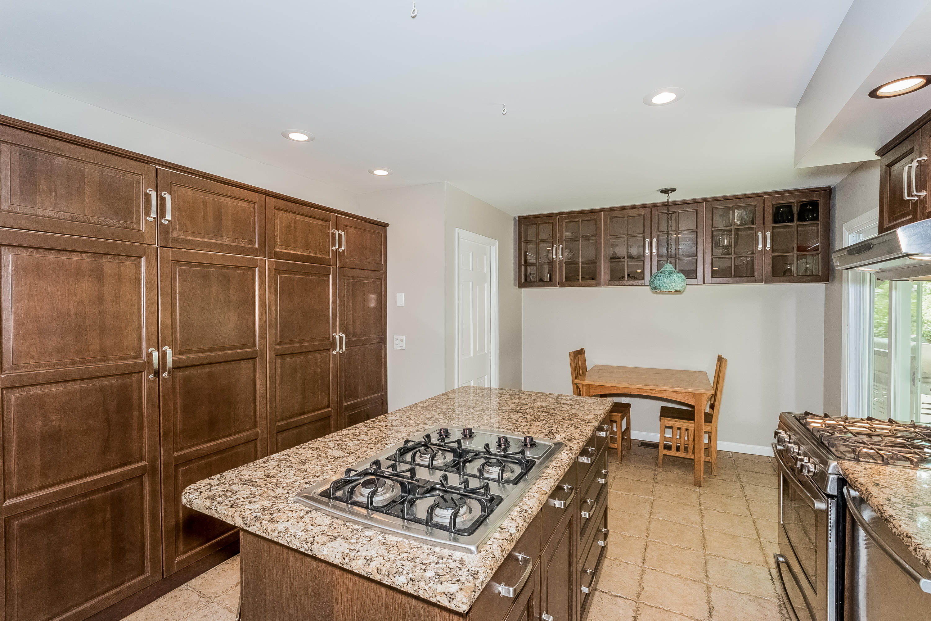 17 Bayberry Hill Road Ridgefield, CT 06877 - Photo 18 of 50 a kitchen with stainless steel appliances granite countertop a stove refrigerator and a dining table