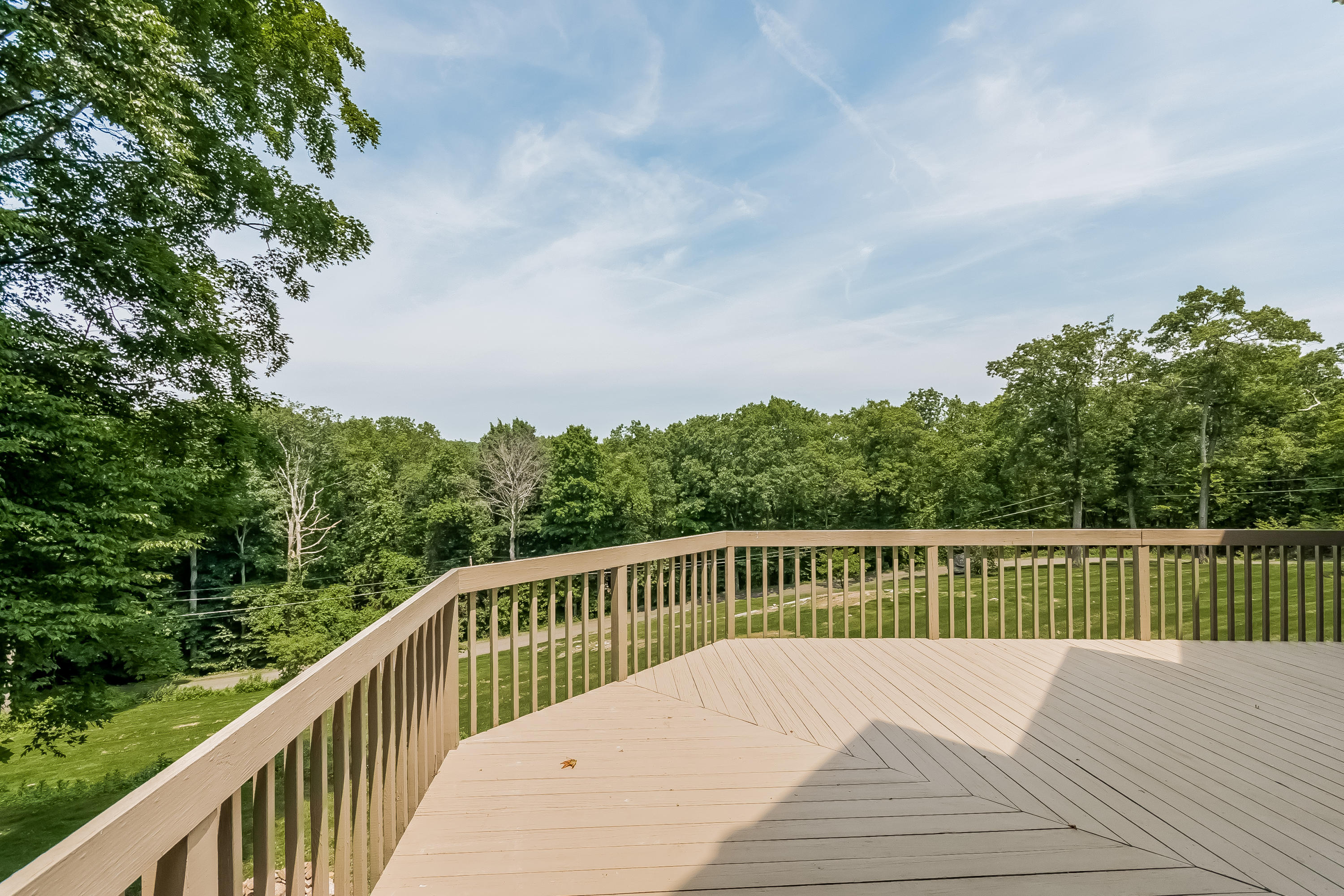17 Bayberry Hill Road Ridgefield, CT 06877 - Photo 8 of 50 a balcony with wooden floor and fence