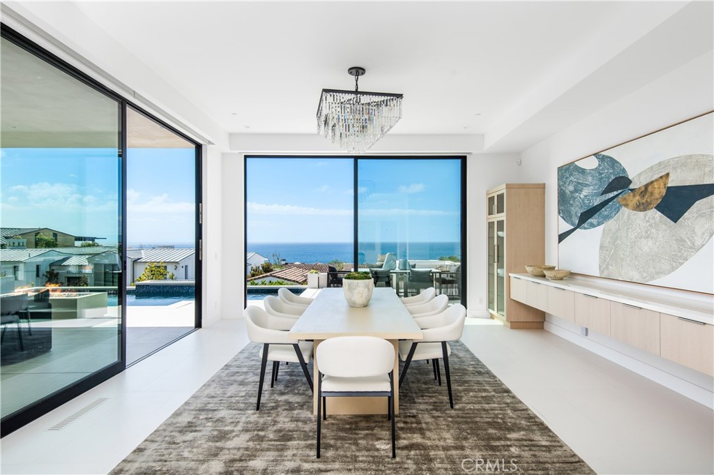 11 Seabreeze Terrace Dana Point, CA 92629 - Photo 11 of 46 a dining room with furniture a chandelier and wooden floor