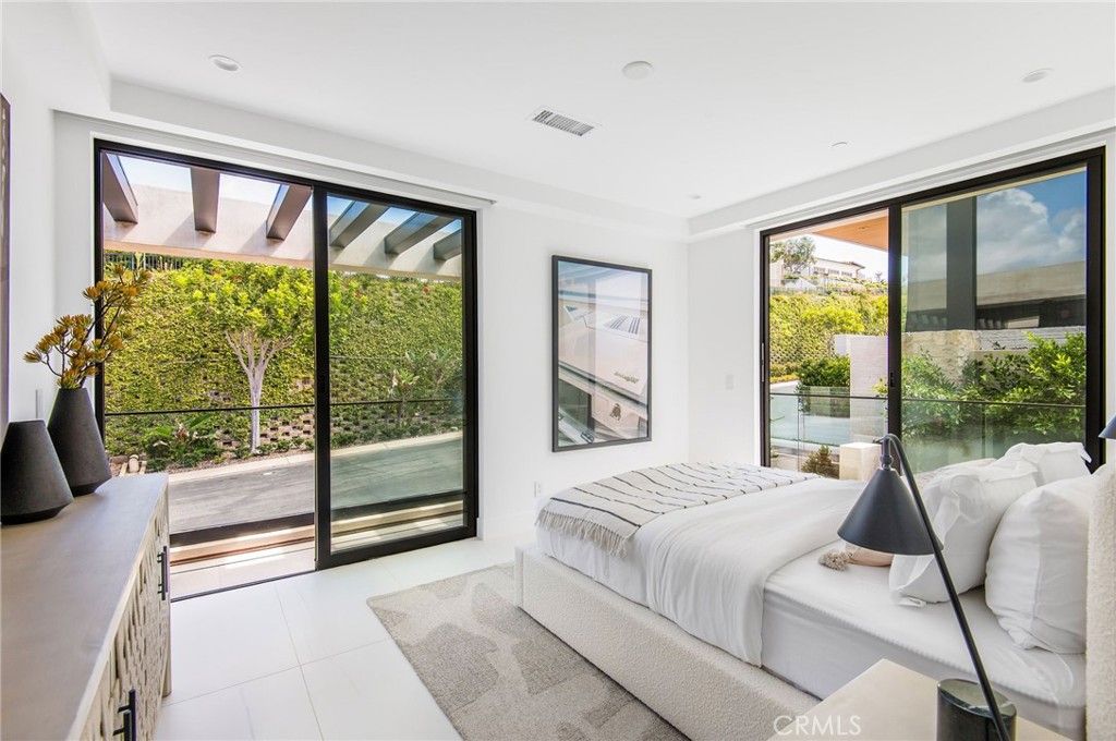 11 Seabreeze Terrace Dana Point, CA 92629 - Photo 22 of 46 a bedroom with a bed and glass window