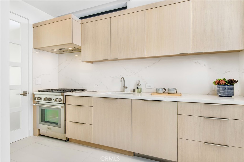 11 Seabreeze Terrace Dana Point, CA 92629 - Photo 35 of 46 a kitchen with cabinets appliances a sink and a counter top space