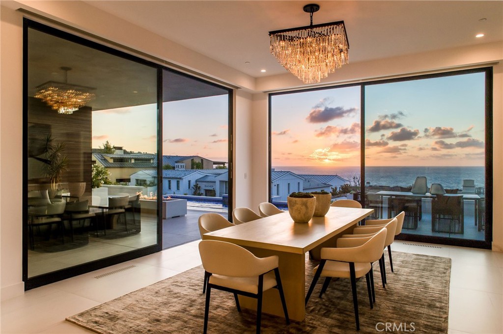 11 Seabreeze Terrace Dana Point, CA 92629 - Photo 4 of 46 a view of a dining room with furniture wooden floor and a floor to ceiling window