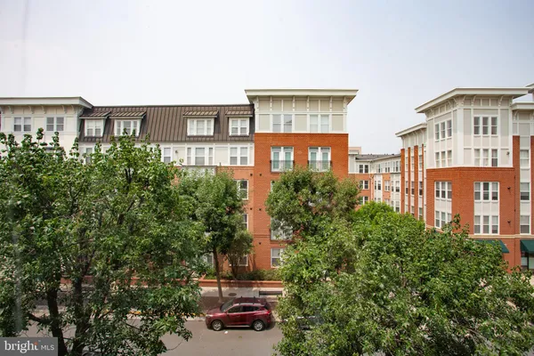 a front view of a residential apartment building with a yard