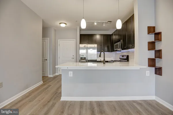 a bathroom with a sink a large mirror and vanity