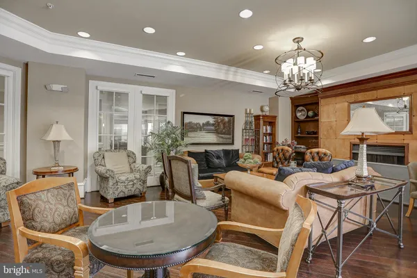 a living room with furniture and a chandelier