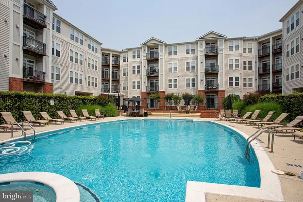 a swimming pool with outdoor seating and yard