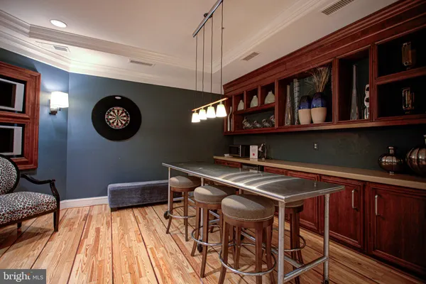 a view of a kitchen with stainless steel appliances granite countertop a cabinets table and chairs