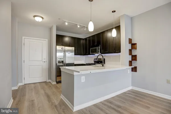 a view of kitchen with kitchen island a sink and a stove
