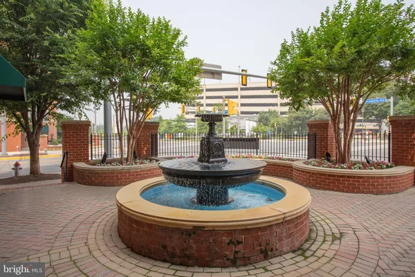 a view of a house with fountain in front of house