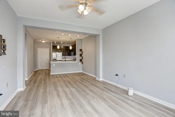 a view of a kitchen with wooden floor and a kitchen
