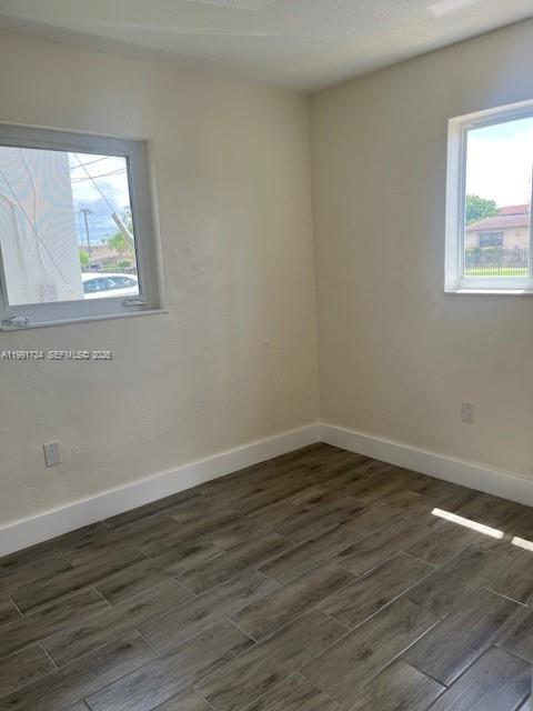 1151 West 28th Street, Unit 1 Hialeah, FL 33010 - Photo 15 of 25 a view of an empty room with wooden floor and a window