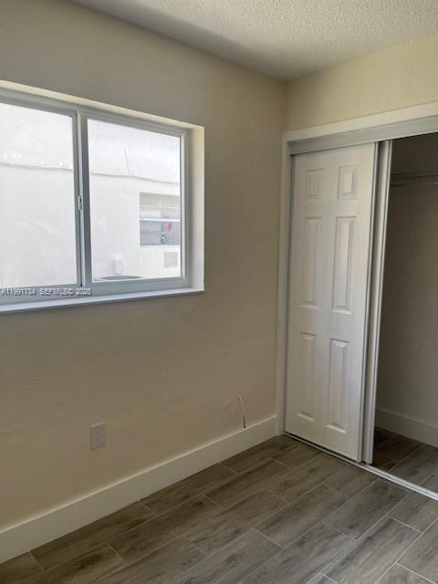 1151 West 28th Street, Unit 1 Hialeah, FL 33010 - Photo 19 of 25 an empty room with wooden floor and windows