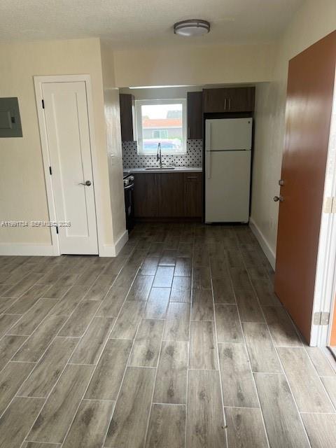 1151 West 28th Street, Unit 1 Hialeah, FL 33010 - Photo 2 of 25 an empty room with wooden floor and cabinet
