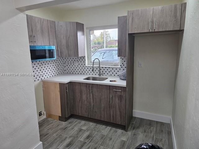 1151 West 28th Street, Unit 1 Hialeah, FL 33010 - Photo 4 of 25 a kitchen with a sink cabinets and wooden floor
