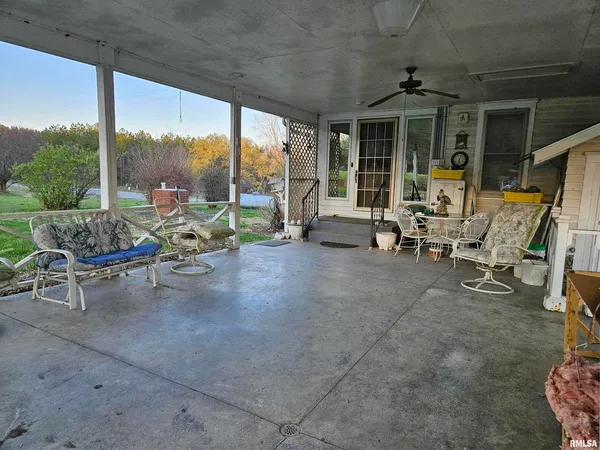 a view of a work space with furniture and floor to ceiling window