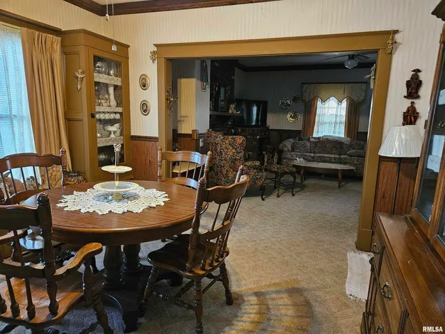 a view of a dining room with furniture and chandelier