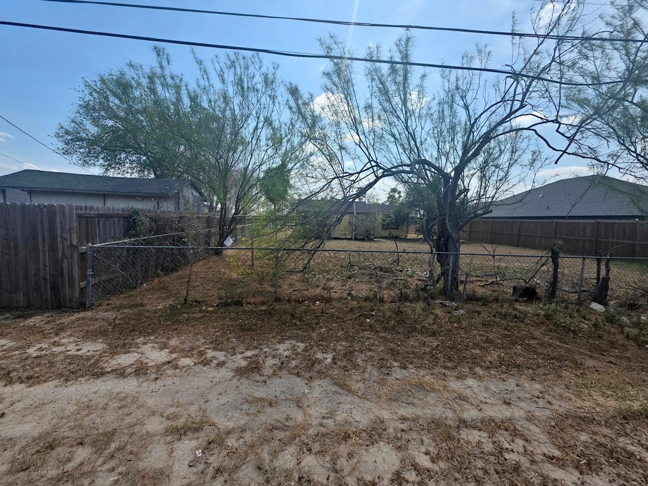 319 East Ricky Crossland Avenue Elsa, TX 78543 - Photo 5 of 8 a backyard of a house with chairs and table