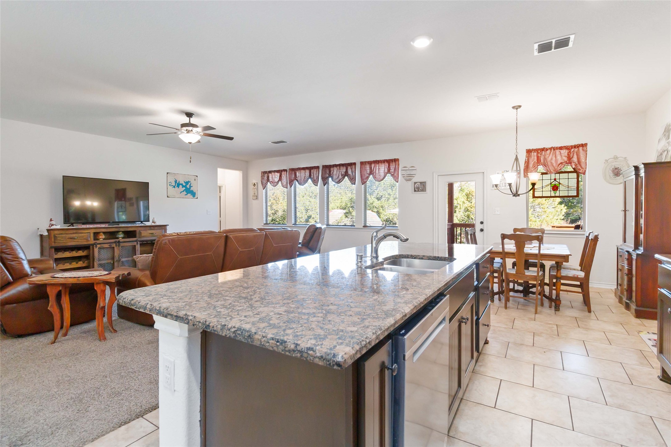 1193 Persimmon Pass Fischer, TX 78623 - Photo 11 of 27 Kitchen with a kitchen breakfast bar, dark brown cabinets, stainless steel appliances