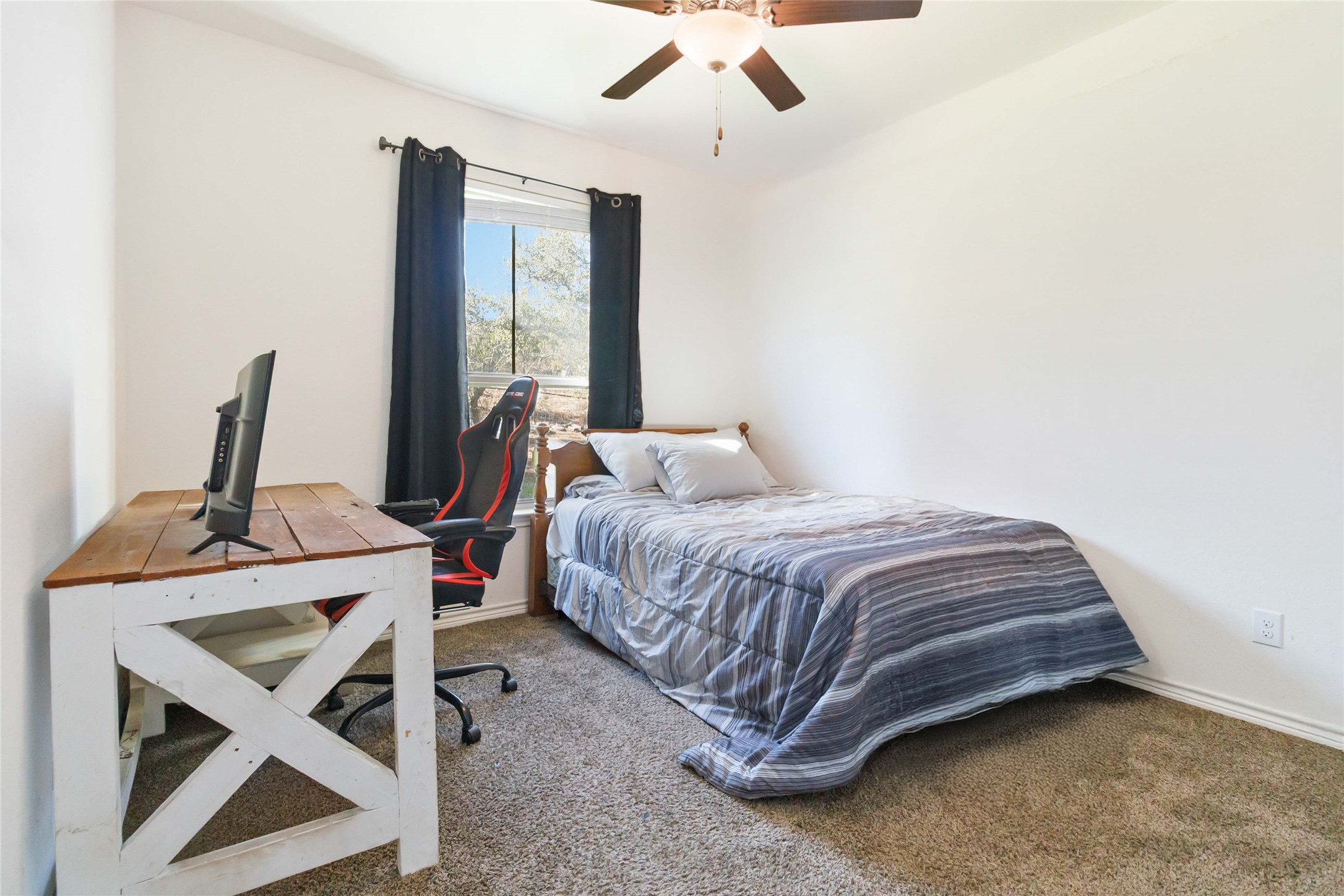 1193 Persimmon Pass Fischer, TX 78623 - Photo 14 of 27 a bedroom with a bed and large window