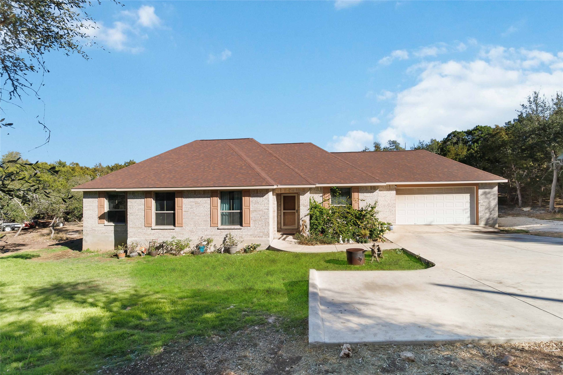 1193 Persimmon Pass Fischer, TX 78623 - Photo 2 of 27 Ranch-style, single story home featuring a yard, driveway, brick exterior and a two car garage