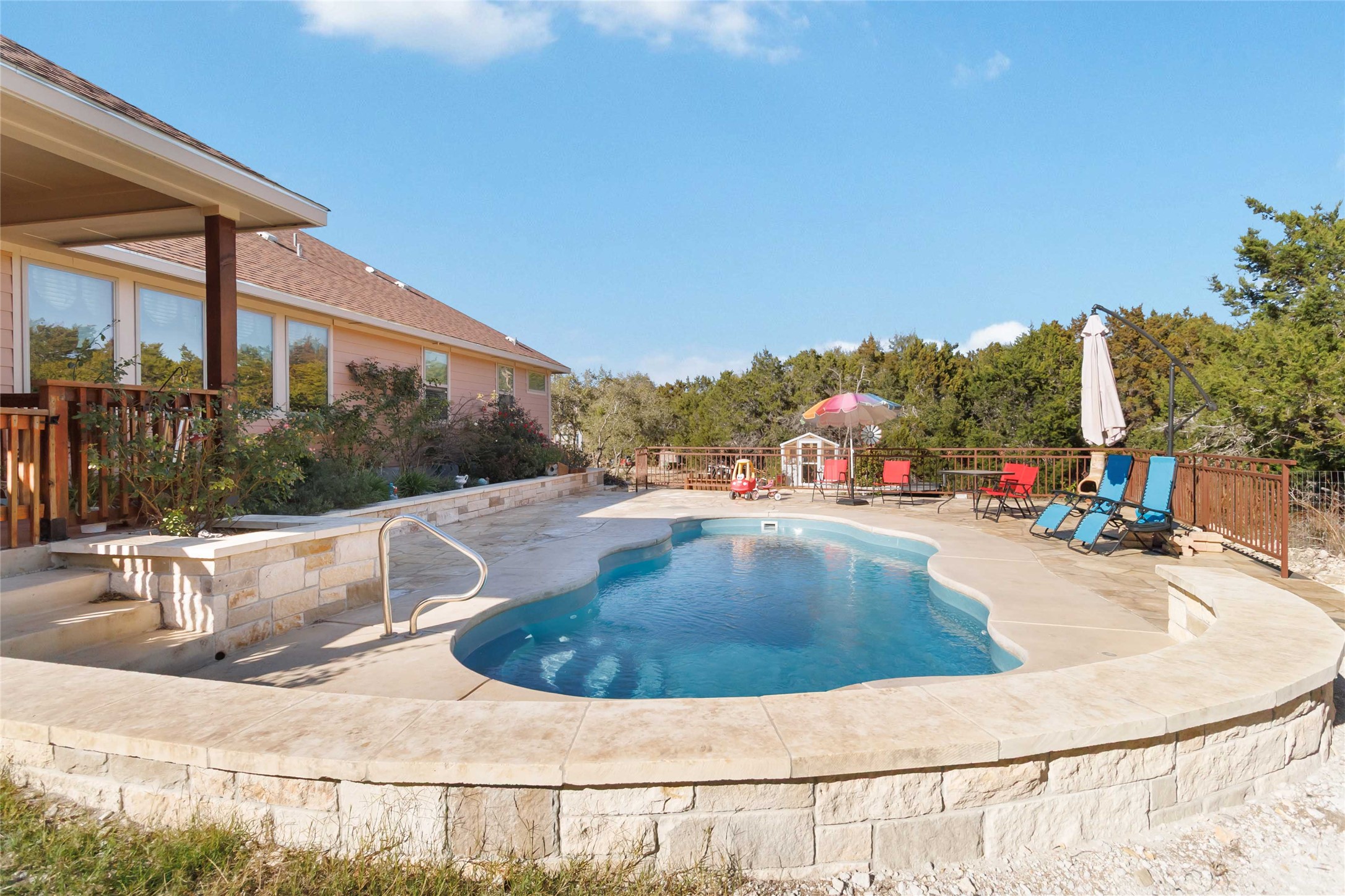 1193 Persimmon Pass Fischer, TX 78623 - Photo 23 of 27 a view of a swimming pool with an outdoor seating and plants