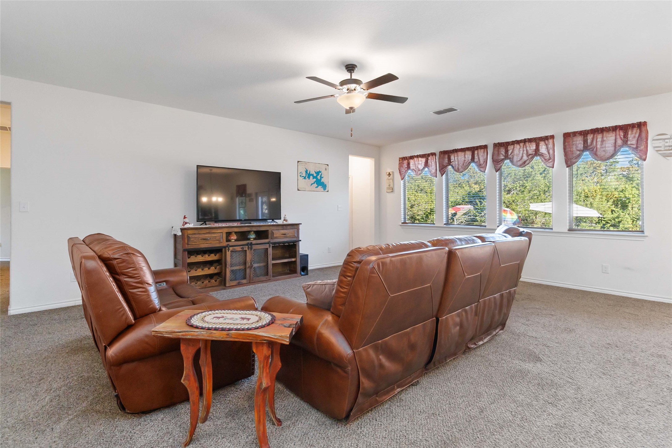 1193 Persimmon Pass Fischer, TX 78623 - Photo 7 of 27 a living room with furniture a large window and a flat screen tv
