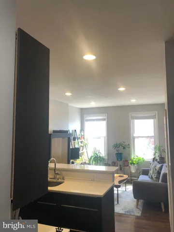 a view of a dining room with furniture a couch and wooden floor