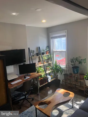 a room with furniture pool table and a window