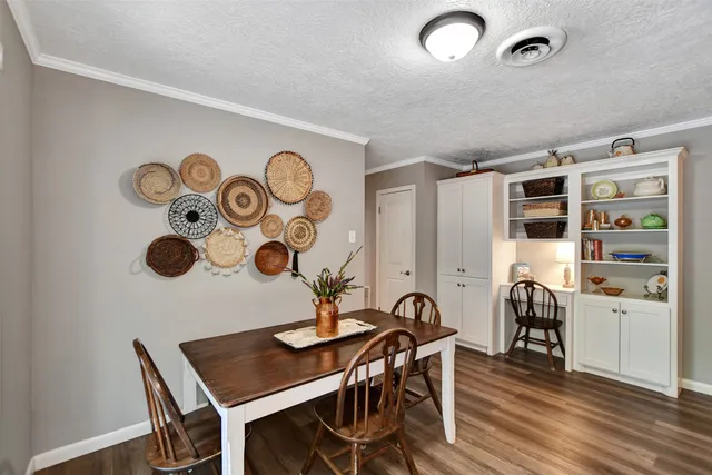 a view of a workspace with furniture and wooden floor