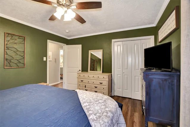 a bedroom with furniture and a flat screen tv