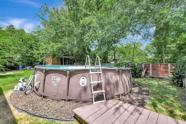 a wooden floor covered with trees in the background