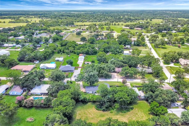 an aerial view of residential houses with outdoor space and swimming pool