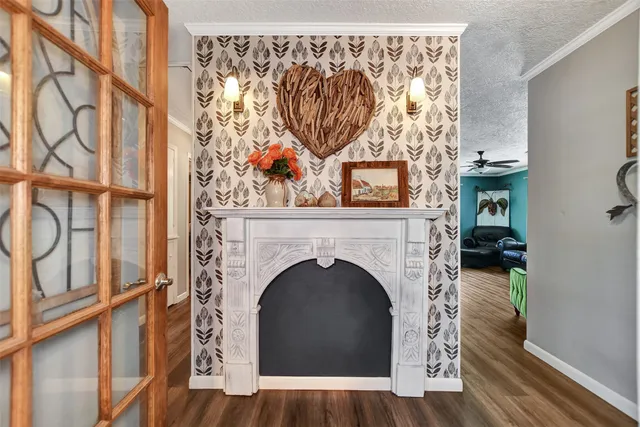 a living room with a fireplace and a wooden floor