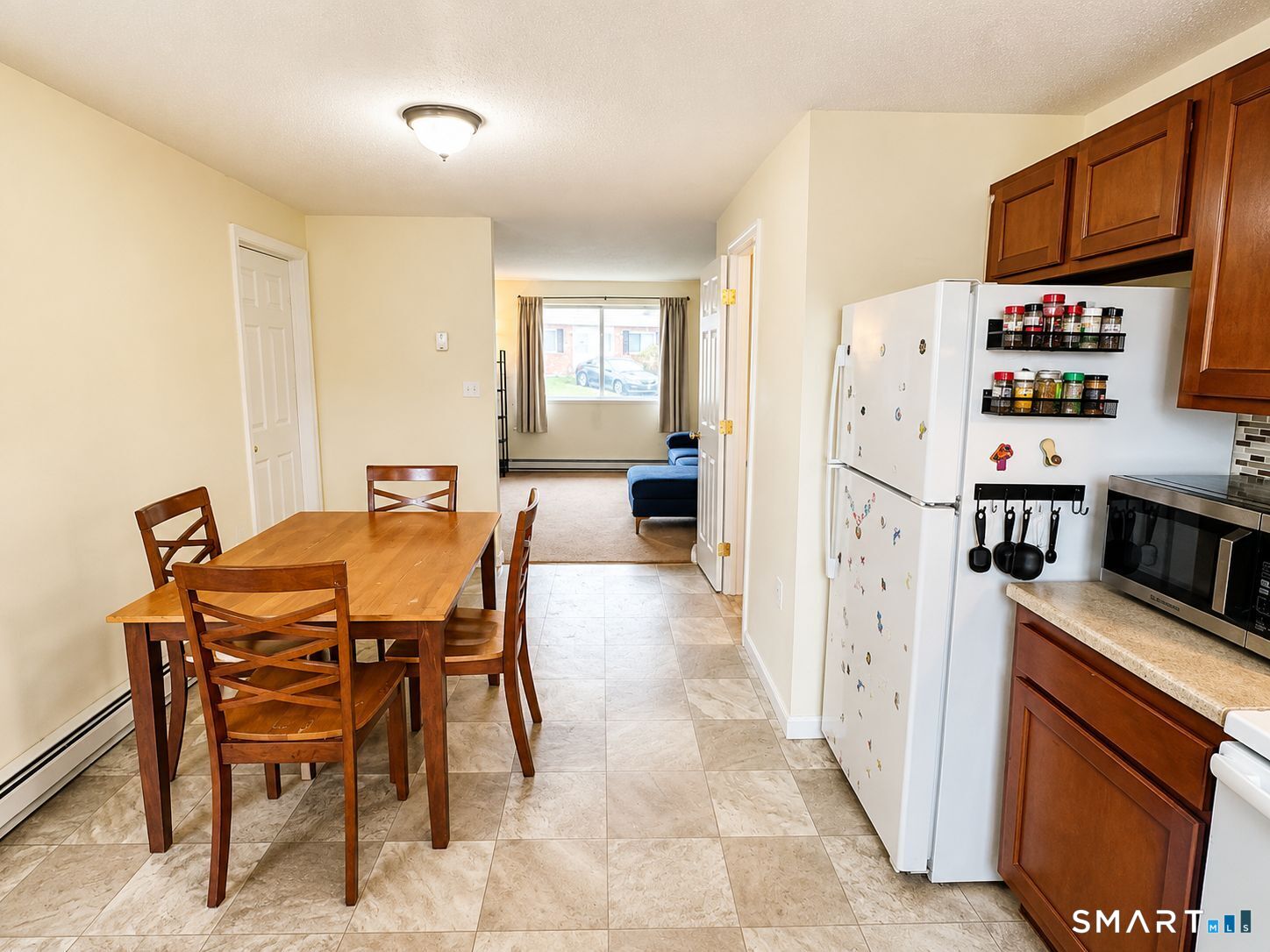 461 Spring Street, Unit 1A Naugatuck, CT 06770 - Photo 5 of 17 a kitchen with stainless steel appliances a refrigerator a stove a dining table and chairs