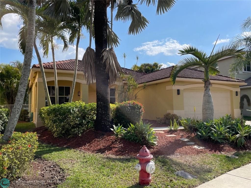 a front view of a house with balcony and garden