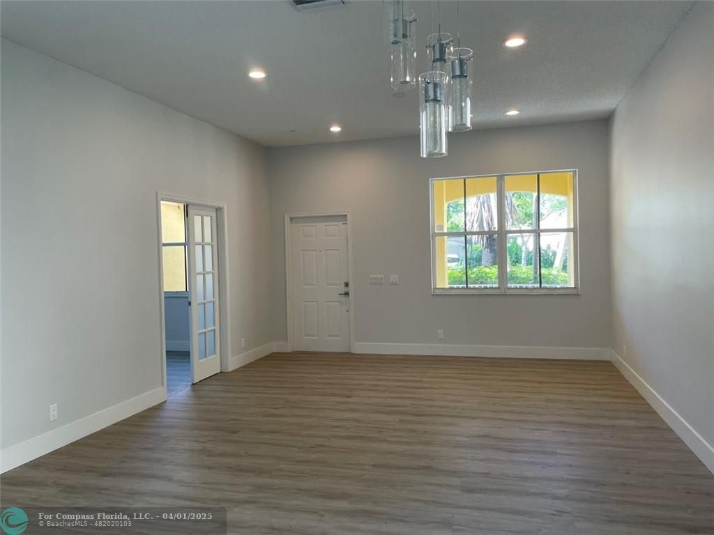 4293 Laurel Ridge Circle Weston, FL 33331 - Photo 11 of 63 an empty room with wooden floor and windows