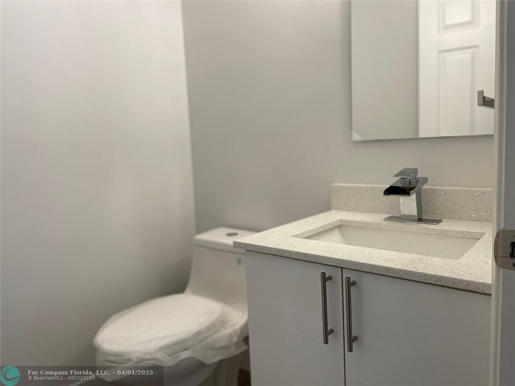 4293 Laurel Ridge Circle Weston, FL 33331 - Photo 15 of 63 a bathroom with a sink a toilet and a mirror