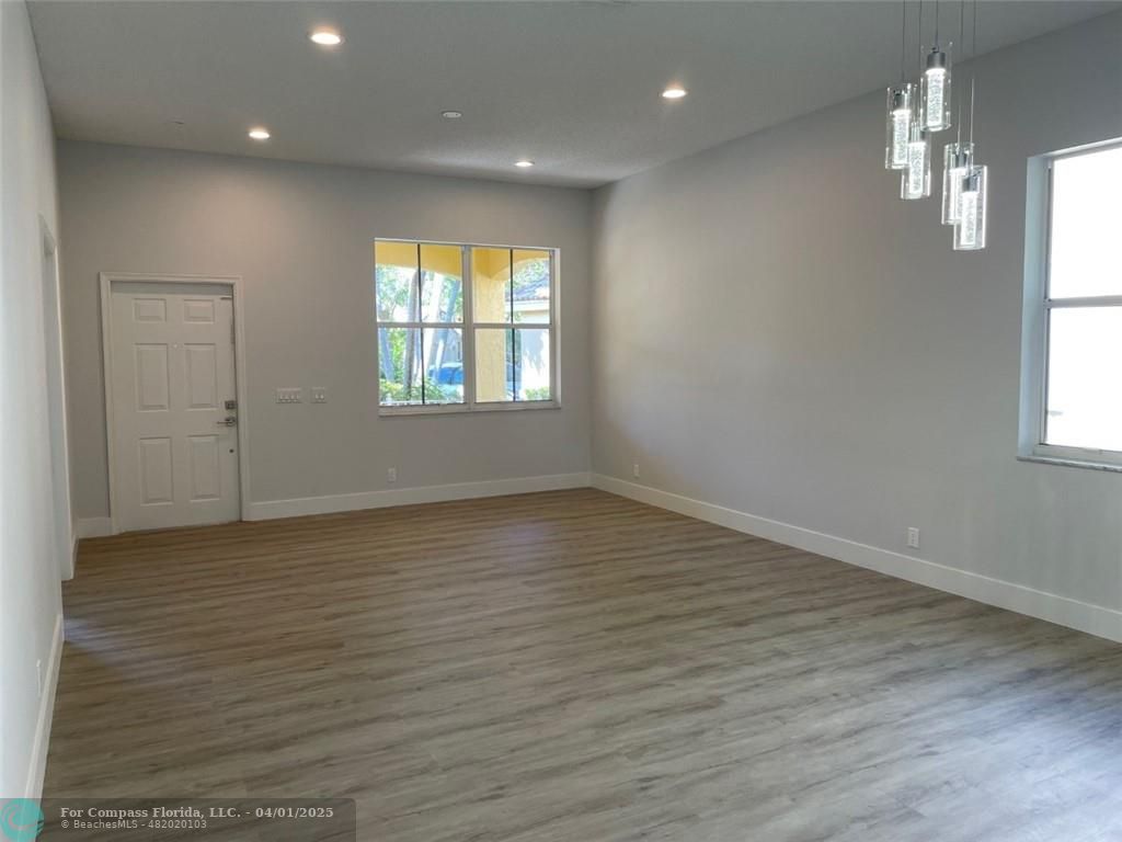 4293 Laurel Ridge Circle Weston, FL 33331 - Photo 18 of 63 an empty room with wooden floor and windows