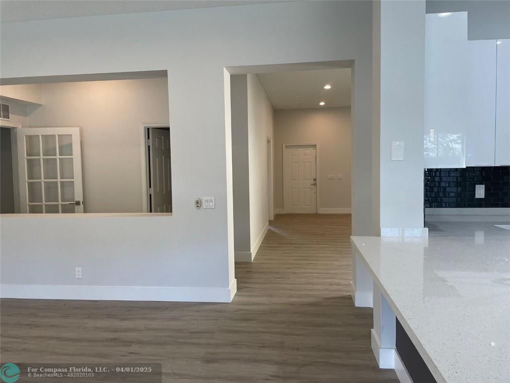 4293 Laurel Ridge Circle Weston, FL 33331 - Photo 25 of 63 a view of a hallway with wooden floor and staircase