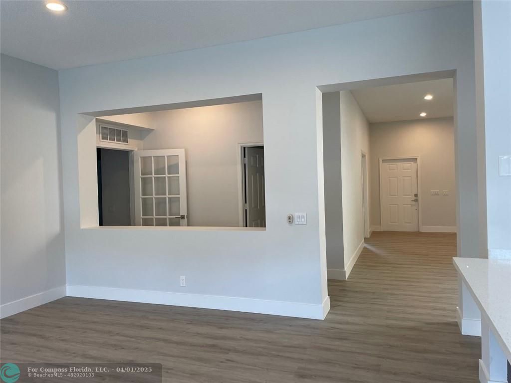 4293 Laurel Ridge Circle Weston, FL 33331 - Photo 26 of 63 a view of an empty room with wooden floor and a mirror