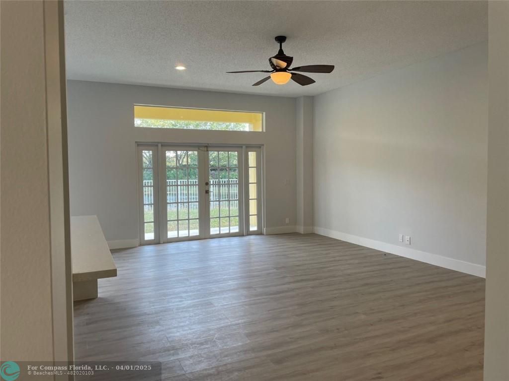 4293 Laurel Ridge Circle Weston, FL 33331 - Photo 27 of 63 a view of an empty room with wooden floor and a window