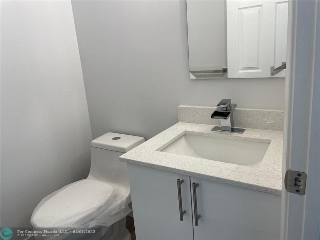 4293 Laurel Ridge Circle Weston, FL 33331 - Photo 30 of 63 a bathroom with a sink toilet and vanity