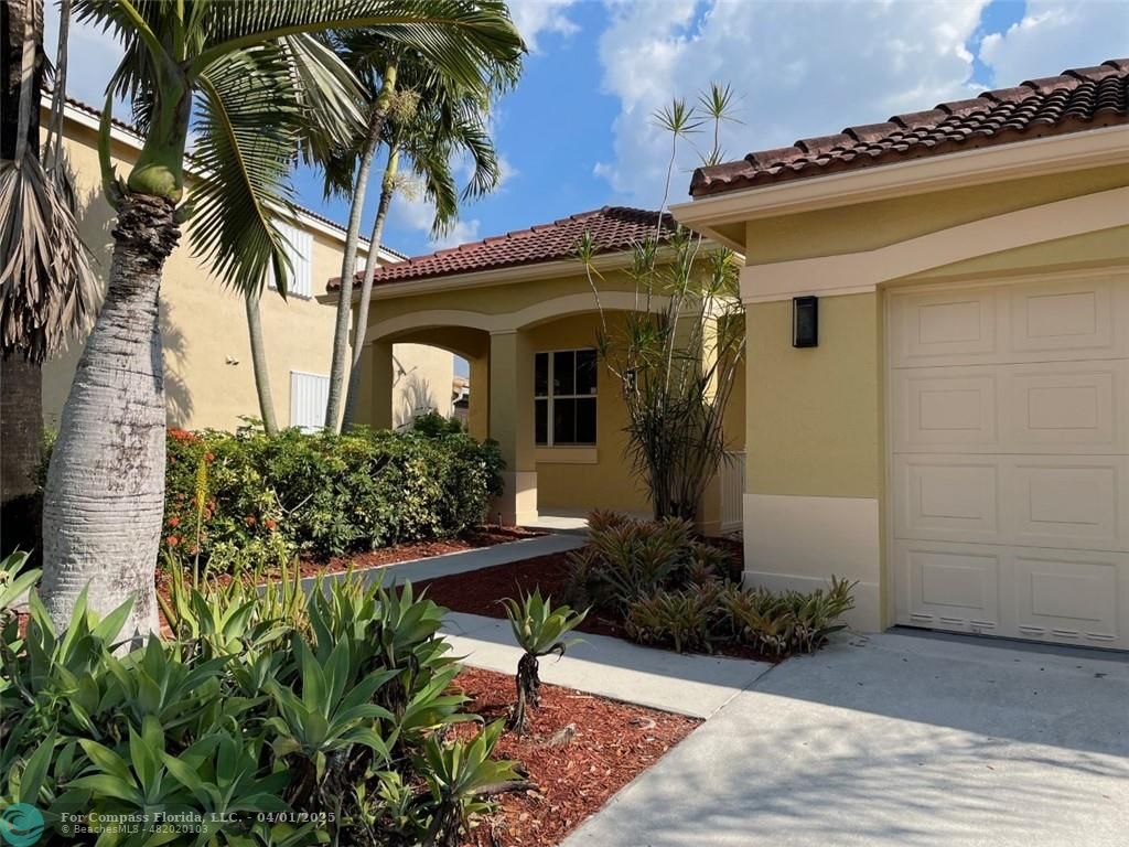 4293 Laurel Ridge Circle Weston, FL 33331 - Photo 4 of 63 a front view of a house with garden