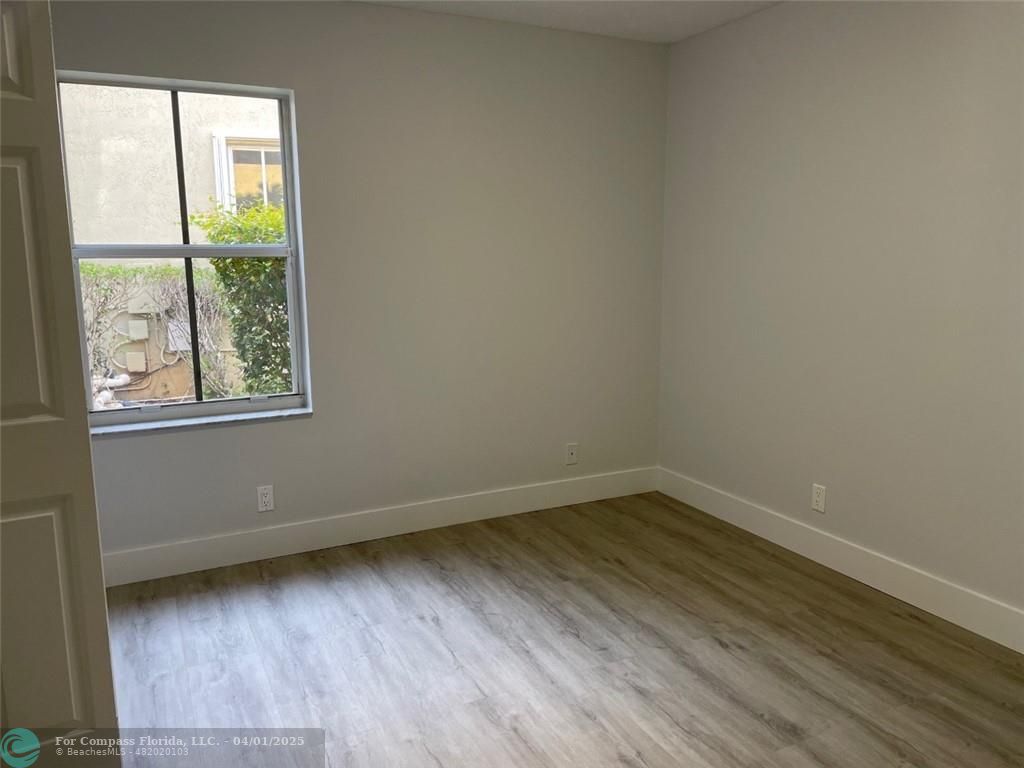 4293 Laurel Ridge Circle Weston, FL 33331 - Photo 50 of 63 an empty room with wooden floor and windows