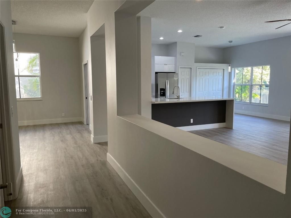 4293 Laurel Ridge Circle Weston, FL 33331 - Photo 57 of 63 an open kitchen with wooden floor and windows