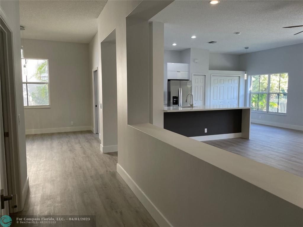 4293 Laurel Ridge Circle Weston, FL 33331 - Photo 58 of 63 an empty room with wooden floor and windows