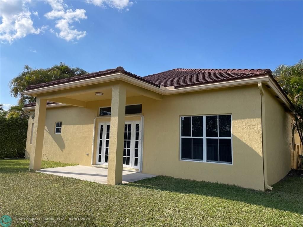 4293 Laurel Ridge Circle Weston, FL 33331 - Photo 62 of 63 a view of a house with a small yard