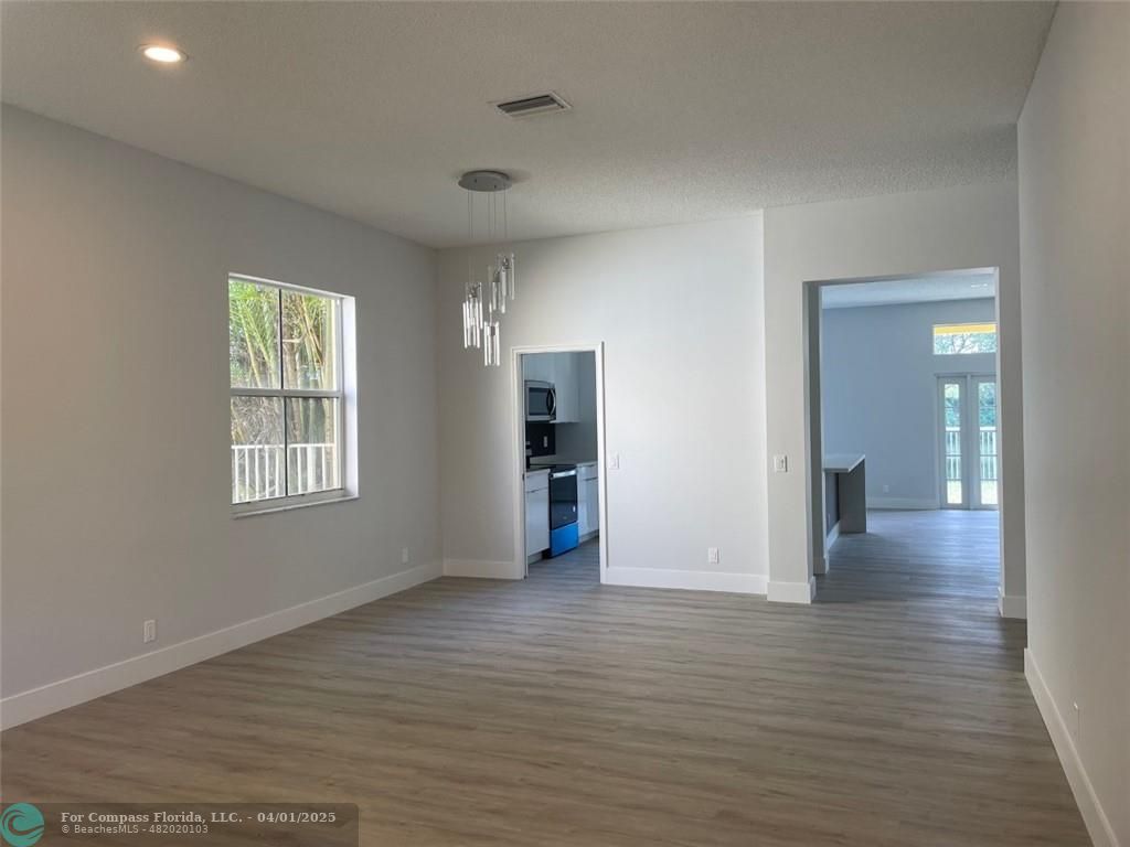4293 Laurel Ridge Circle Weston, FL 33331 - Photo 7 of 63 a view of an empty room with wooden floor and a window