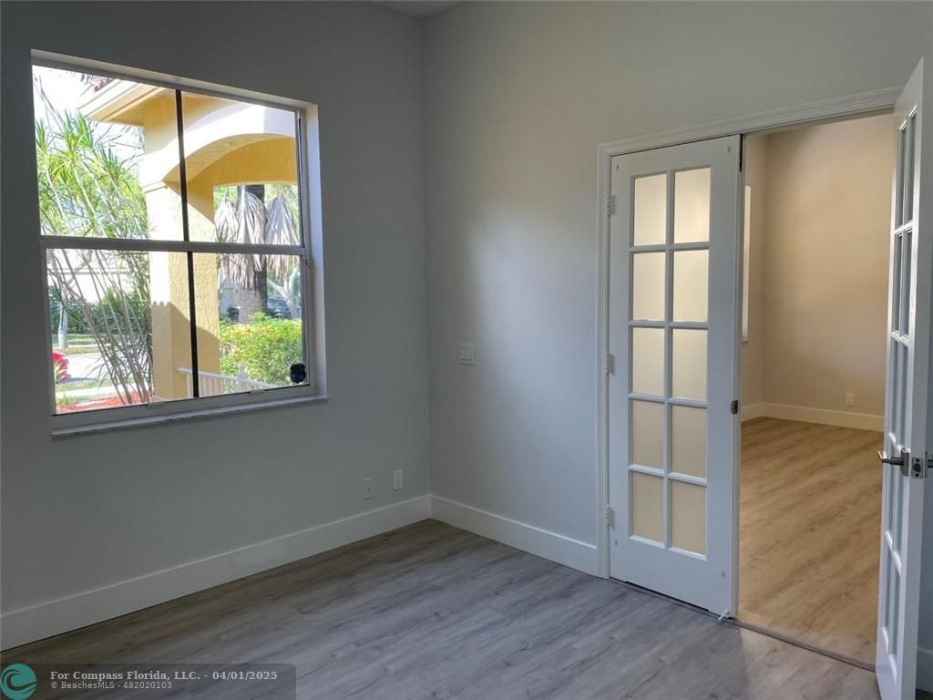 4293 Laurel Ridge Circle Weston, FL 33331 - Photo 9 of 63 an empty room with wooden floor and windows